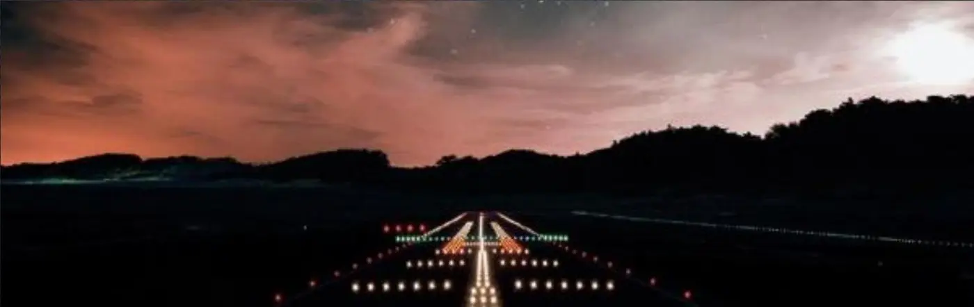 Pista de aeropuerto iluminada de noche